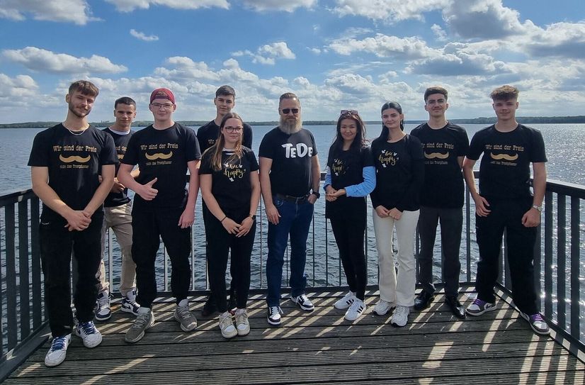Tobias Dorn, Geschäftsführer KWG und BMA (Mitte), mit den neuen Auszubildenden und dem BA-Studierenden.