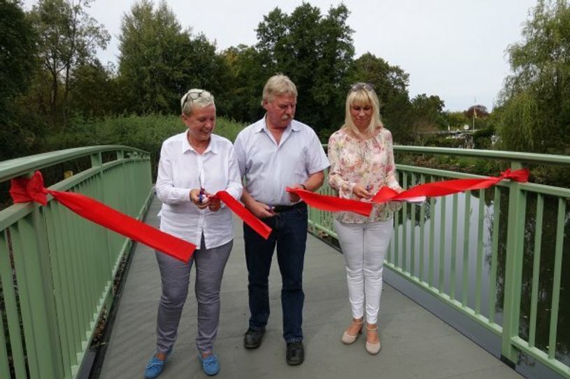 Simone Taubenek, Ullrich Dunkel und Heike Korittke (v.l.) eröffneten mit dem Durchschnitt des roten Bandes die Brücke nun offiziell. Foto: Stadt Forst