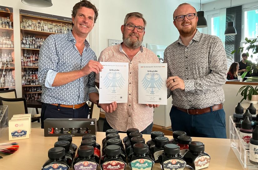v.l.n.r. Gunther Lange (Octopus) mit Torsten Meisel und Benjamin Venter (BAROCK-EVENTPARK) mit ihren Urkunden vom Patentamt O2 Octopus-Produktionsmitarbeiter Uwe Giesen klebt die Tinten-Schildchen noch von Hand auf.