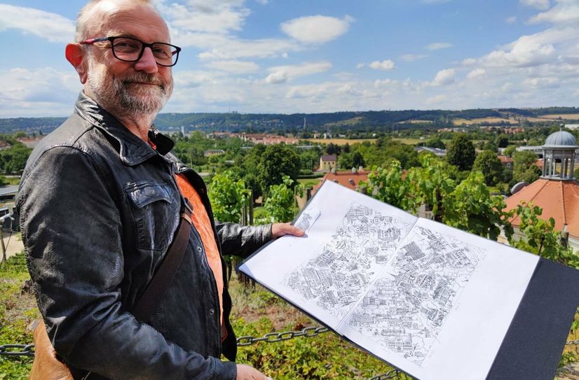 Karikaturist Lutz Richter mit dem Wimmelbild.