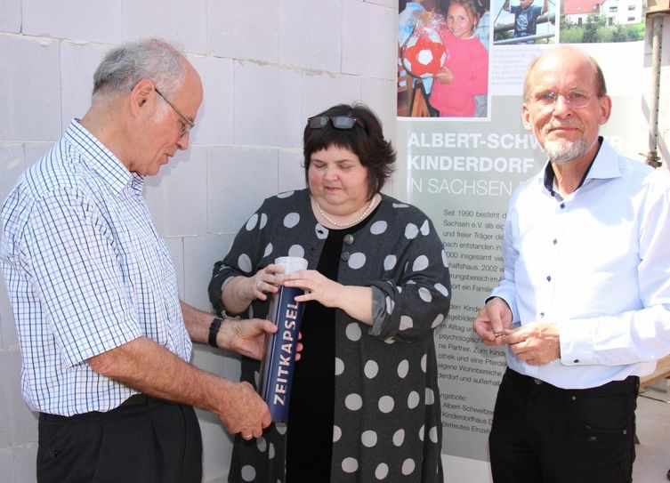 Dr. Hans Geisler (Schirmherr Albert-Schweitzer-Kinderdorf Sachsen e.V.), Wilma Jessen (Sozialministerium) und Frank Richter (Geschäftsführer des Vereins, v.l.) beim Befüllen der Zeitkapsel