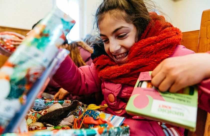 Ein rumänisches Mädchen packt einen Schuhkarton aus. Foto: David Vogt