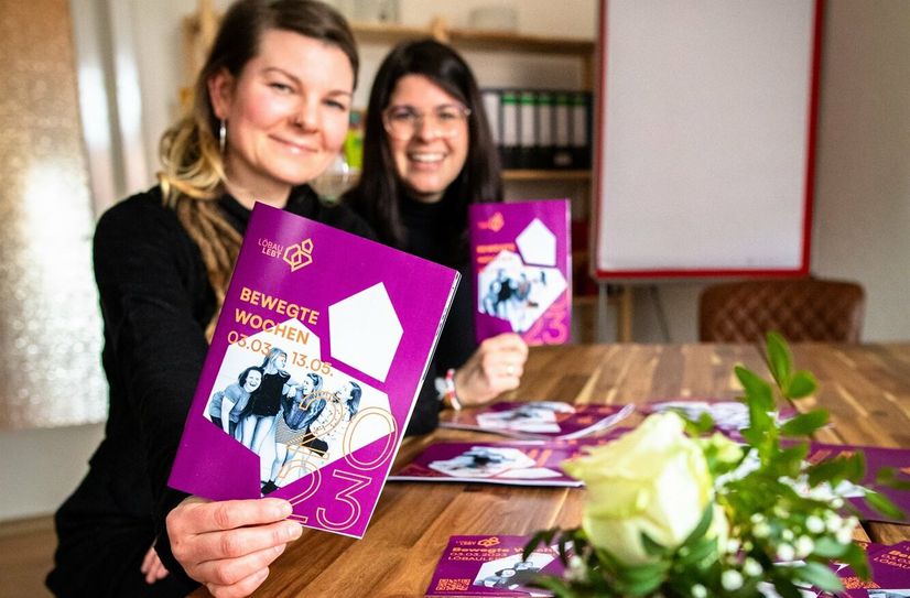 Projektleiterin Claudia Lang (links) und Laura Friedrich zeigen das Programmheft zu den Bewegten Wochen.