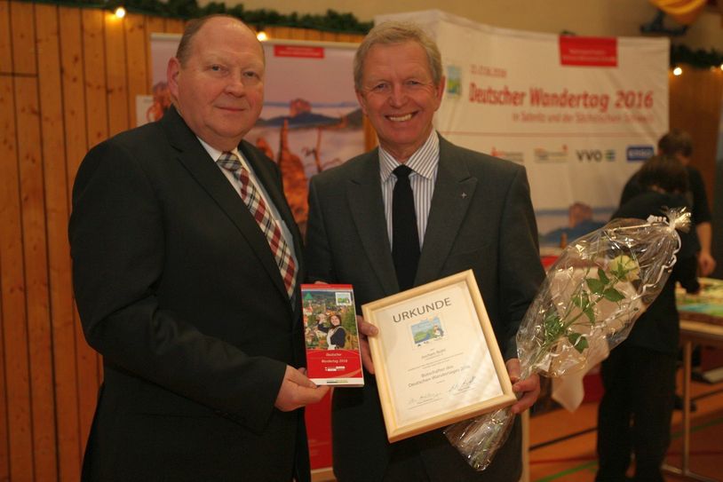 Klaus Brähmig (li.) übergibt Jochen Bohl die Ernennungsurkunde und das Programm des Wandertages.       Foto: Förster