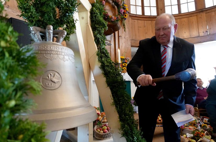 Klaus Brähmig macht während der Glockenweihe die ersten drei Schläge.