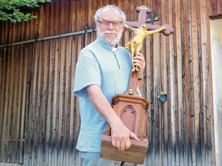 Pfarrer Stefan Schwarzenberg mit dem geretteten Altarkreuz aus der Sakristei der Großröhrsdorfer Kirche. Für ihn ist dieses Kreuz das Zeichen für einen Neuanfang. Foto: Matthias Stark