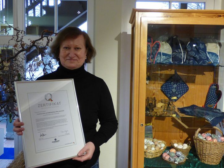 Q-Coach Renate Draunick zeigt stellvertretend für das gesamte Team im Spreewald-Service Lübben die Urkunde zur Stufe II der ServiceQualität Deutschland. Foto: TKS Lübben (Spreewald) GmbH