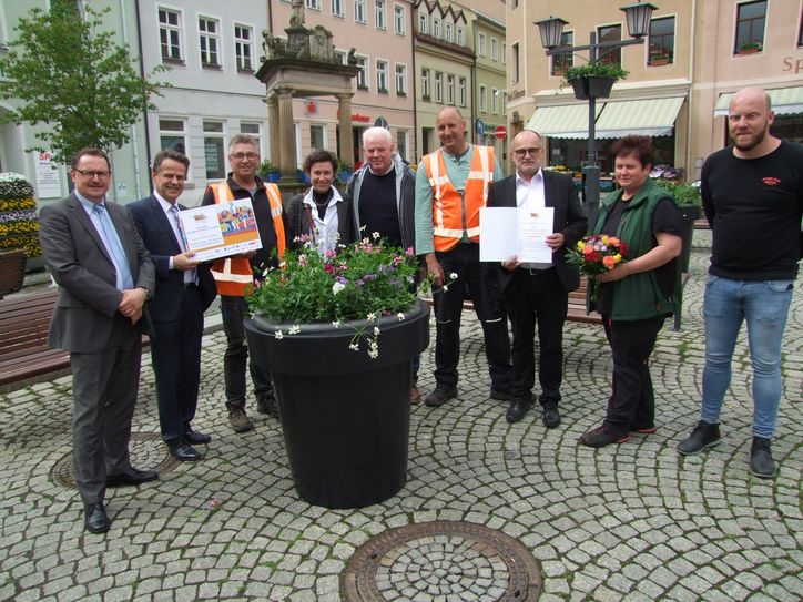 Nach der Scheckübergabe durch Eddy Donat von der IHK Dresden (2.v.l.) an Oberbürgermeister Roland Dantz (3.v.re.) ging es auf den Marktplatz, wo Mitarbeiter des niederländischen Unternehmens bereits erste Blühpflanzen aufgestellt hatten. Foto: Rainer Könen