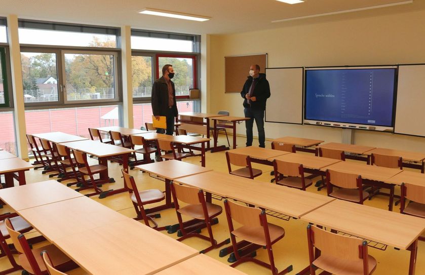 Bürgermeister Lars Kolan und René Pötschick, technischer Sachbearbeiter im Gebäudemanagement, in einem Klassenraum. Foto: Stadtverwaltung