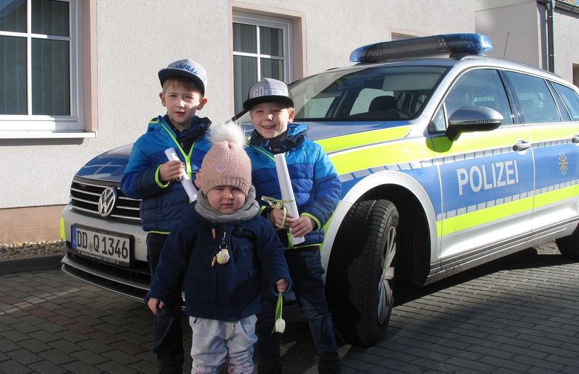 Die drei Kinder vor dem Streifenwagen. Foto: Polizei