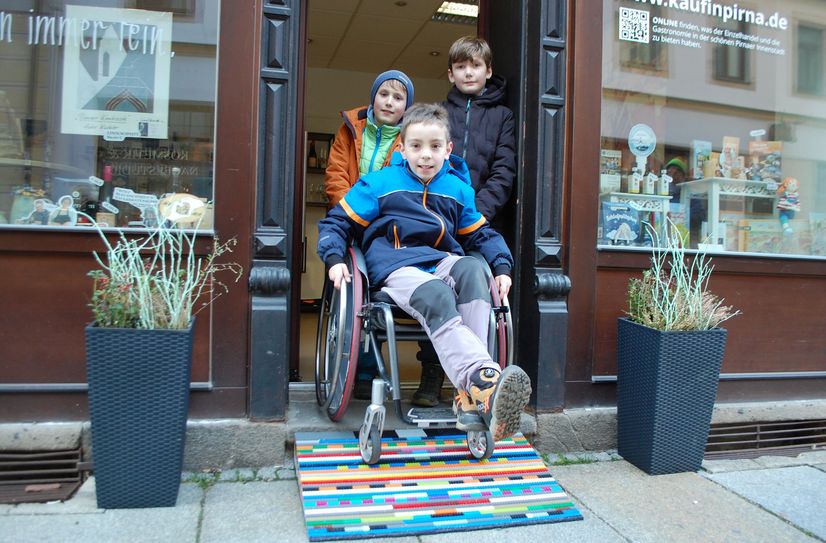 Richard, Endrik und Adrian (v. l. n. r.) probierten im Februar die von ihnen gebaute erste LEGO-Rampe für die Pirnaer Altstadt am Eingang des KiP-Lädchens des Citymanagements aus.