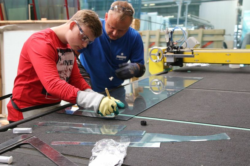 Felix (l.), Achtklässler der Oberschule Ebersbach, testet beim Besuch der Firma Schollglas in Nossen das Glasschneiden. Er interessiert sich für eine Ausbildungsstelle im Bereich der Industrie und möchte Mechatroniker werden. Fotos: Farrar