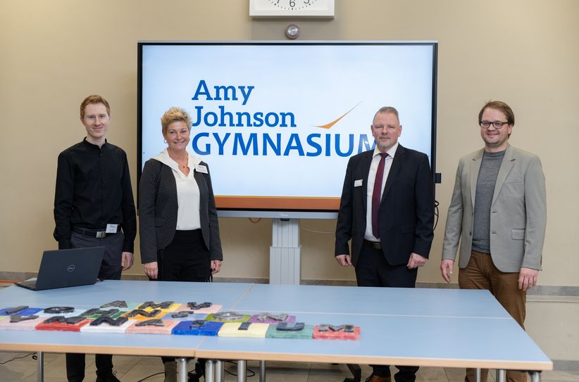 Der neue Name des Gymnasiums »Amy-Johnson-Gymnasium« wird vorgestellt: Kay Klatt, stellvertretender Schulleiter, Daniela Günther, Schulleiterin Amy-Johnson-Gymnasium, Stefan Klein, Dezernent für Finanzen, Schulen und innere Verwaltung des LDS, Christian Könning, Gemeinde Schönefeld.