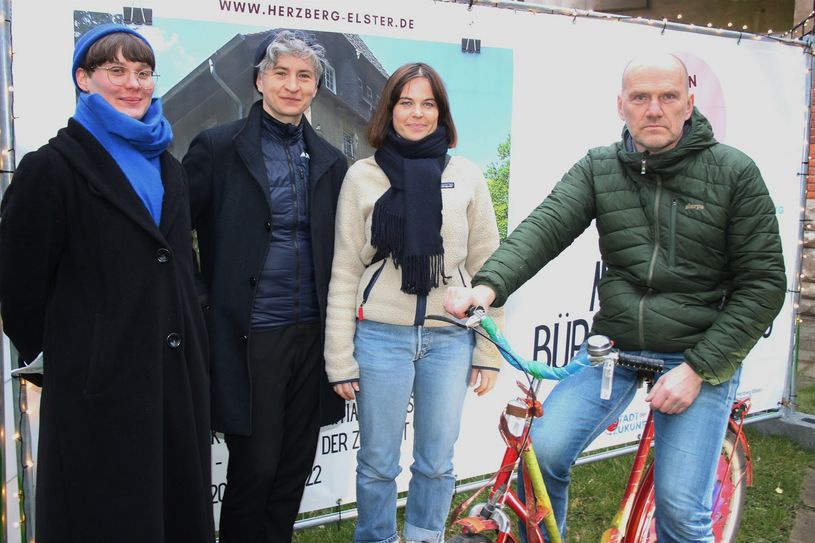 Auf dem »Wünschefahrrad« der Stadt Herzberg: Bürgermeister Karsten Eule-Prütz angefeuert von Lena Heiss (2.v.r.) vom Team Zukunftsorte Brandenburg.