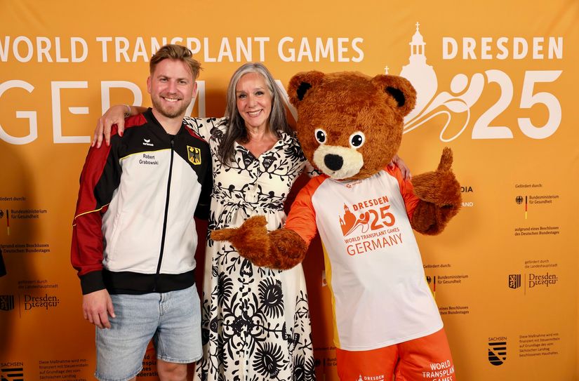 Robert Grabowski (Teilnehmer und Botschafter), Liz Schick (Präsidentin WTGF) und Maskottchen »TX«.